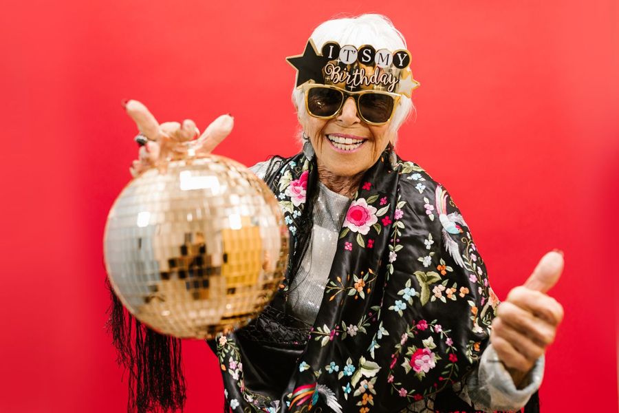 Ältere Frau mit Discokugel